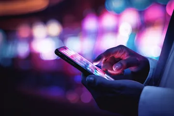 2J777 Slots — Thousands of thrilling machines await A woman smiling by bright slot machines showing lucky symbols, showcasing the exciting slot offerings at 2J777.